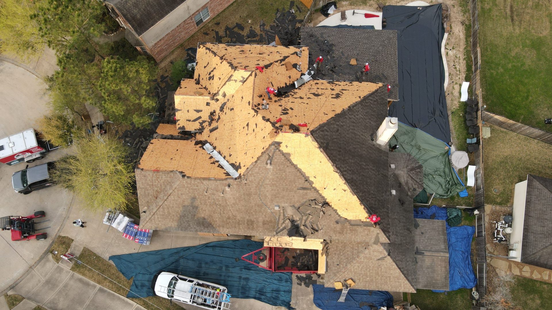 Roofing contractors installing a new roof on a residential property in Katy, TX